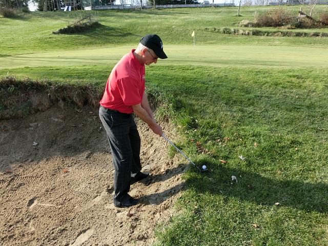 Ball above feet bunker shot golf swing tips